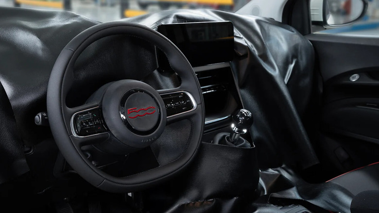 the interior of the new 500 Hybrid with everything covered but the steering wheel and center console