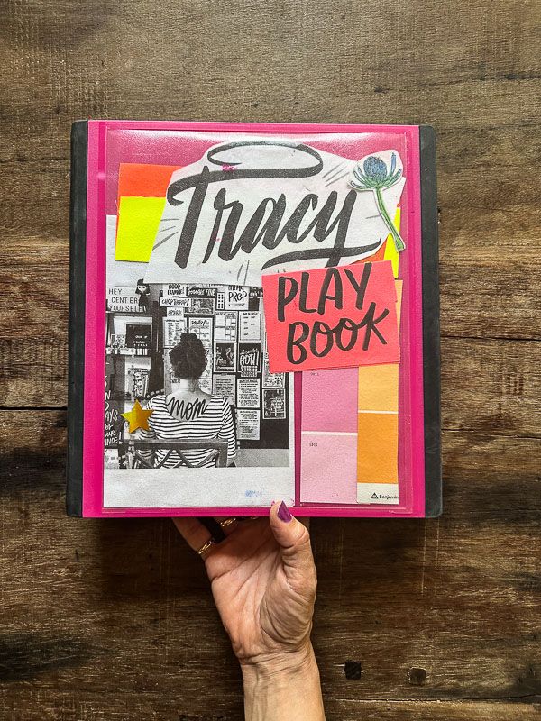This may contain: a person holding up a book with the title tiny play book written in black on it