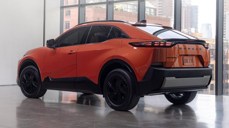 Rear 3/4 view of an orange 2026 Subaru Uncharted