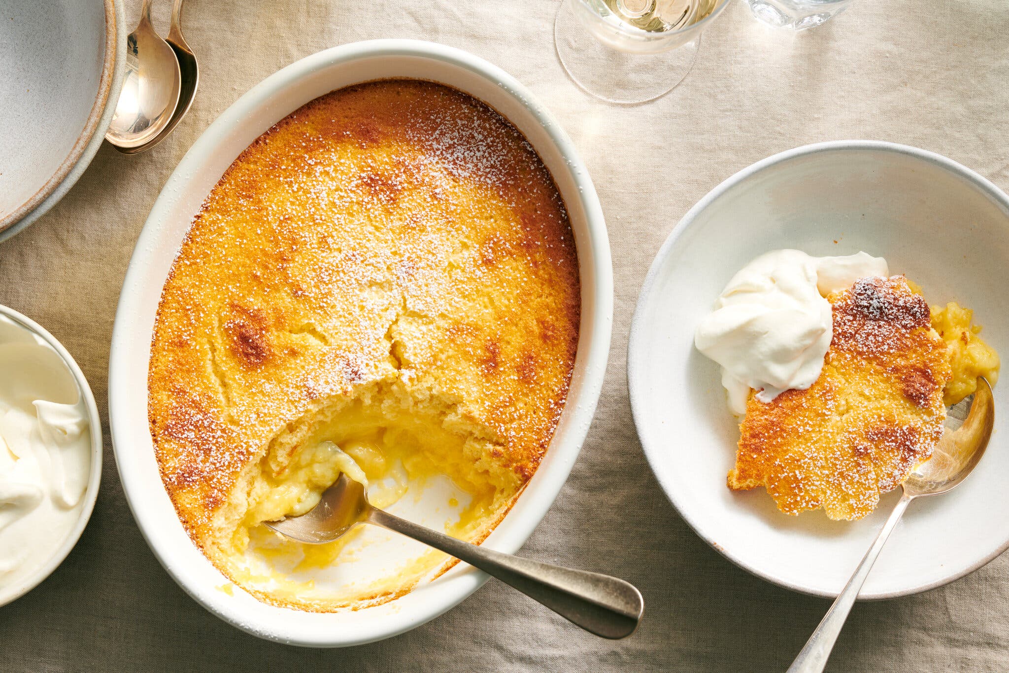 An overhead image of a burnished lemon pudding with a scoop taken out.