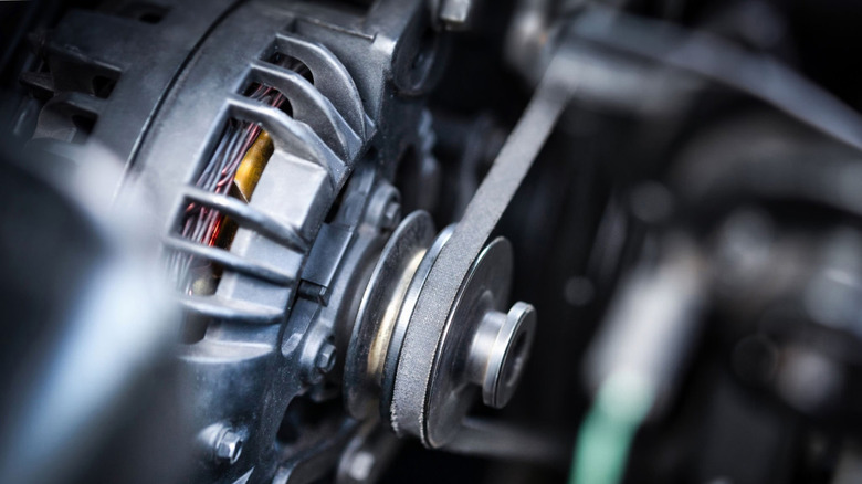 A V-belt wrapped around an alternator pulley.